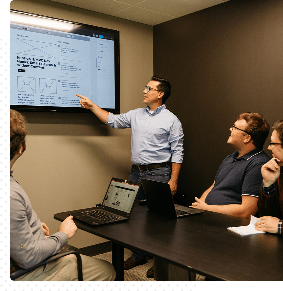 A man with glasses presenting findings to the team.