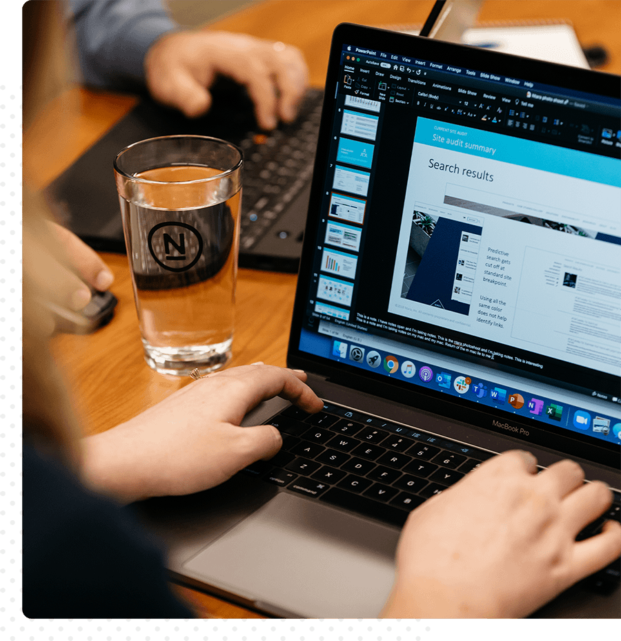 A woman working on a presentation on her laptop.