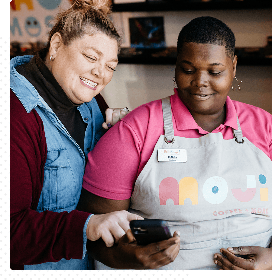 Two people working together at Mojo's coffee shop.