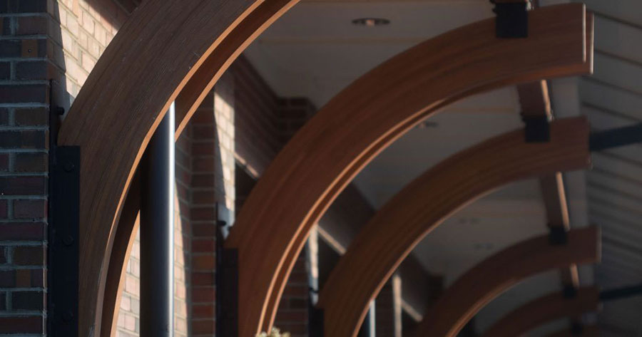 An abstract image of a walkway with curved wooden supporting beams in Downtown Johnson City.