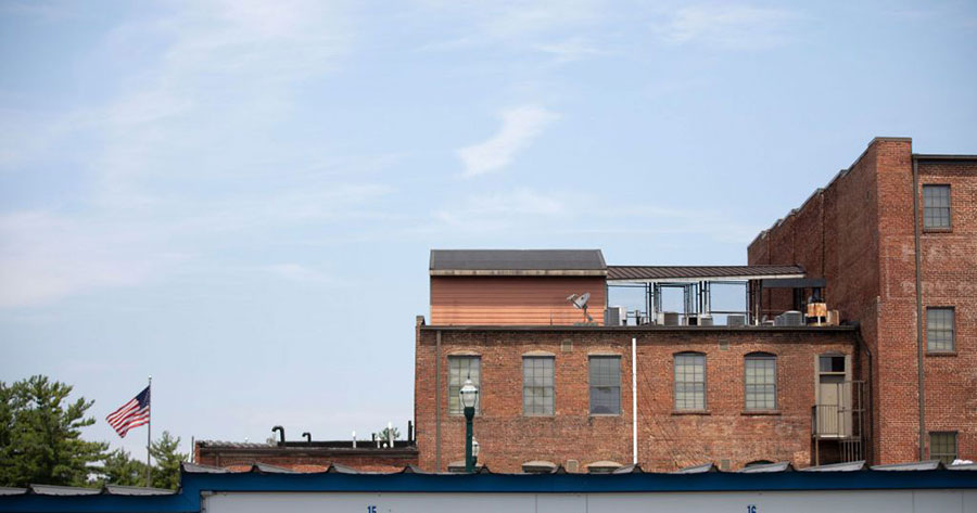An image of brown brick buildings against a blue sky. Downtown Johnson City, TN.