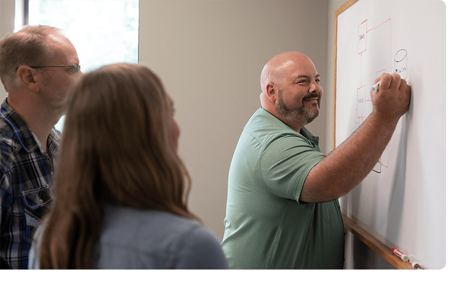 Ntara team working on a white board.