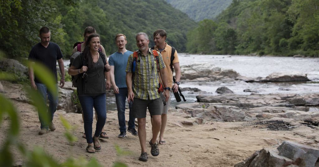 Ntara coworkers hike along river in Northeast Tennessee in the summer time.