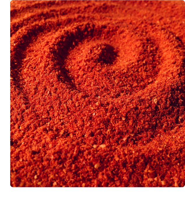 Abstract image of red sand, swirled into a spiral.