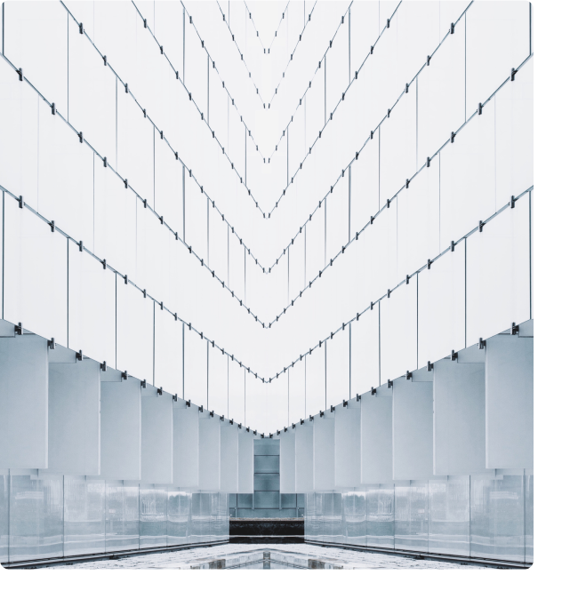 Group 148(2) Abstract image of a very tall room with floor-to-ceiling windows. The lower level of the windows are gray and show nondescript reflections from inside the room.