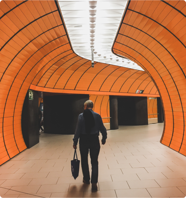 image4 Man walking down an orange and white hallway