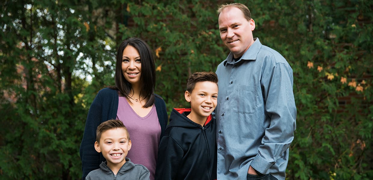 Image of a family: a mom, a dad, and two boys of different ages.